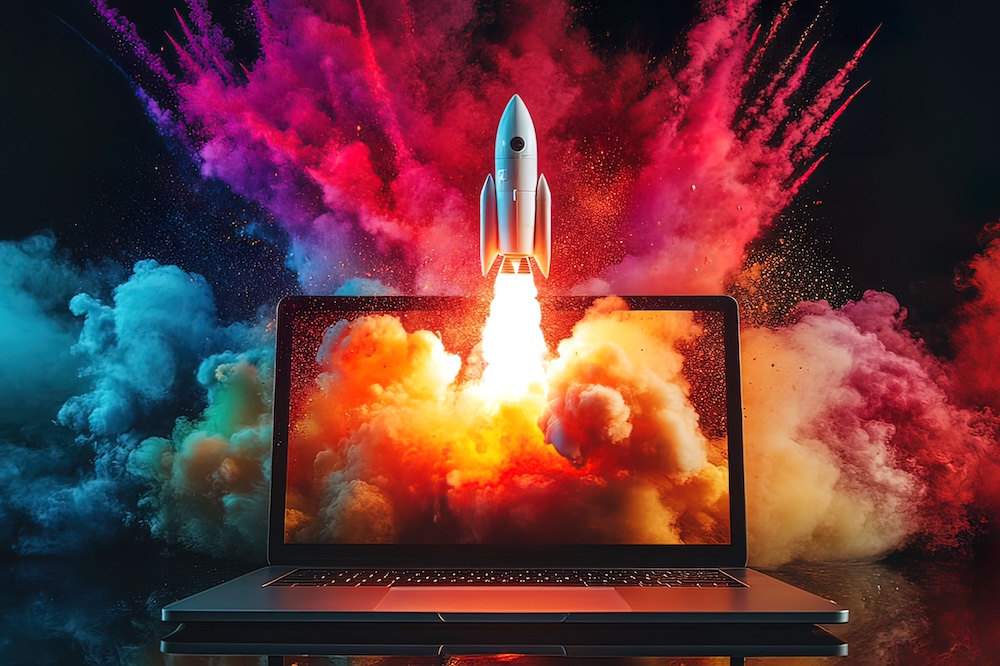 Rocket launching from laptop screen amidst vibrant colorful smoke and fire. Redesign or Refresh? Knowing When It’s Time to Evolve Your Website